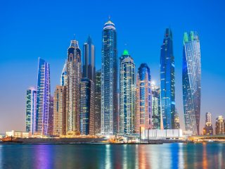 Colorful building and harbor of a city at night time